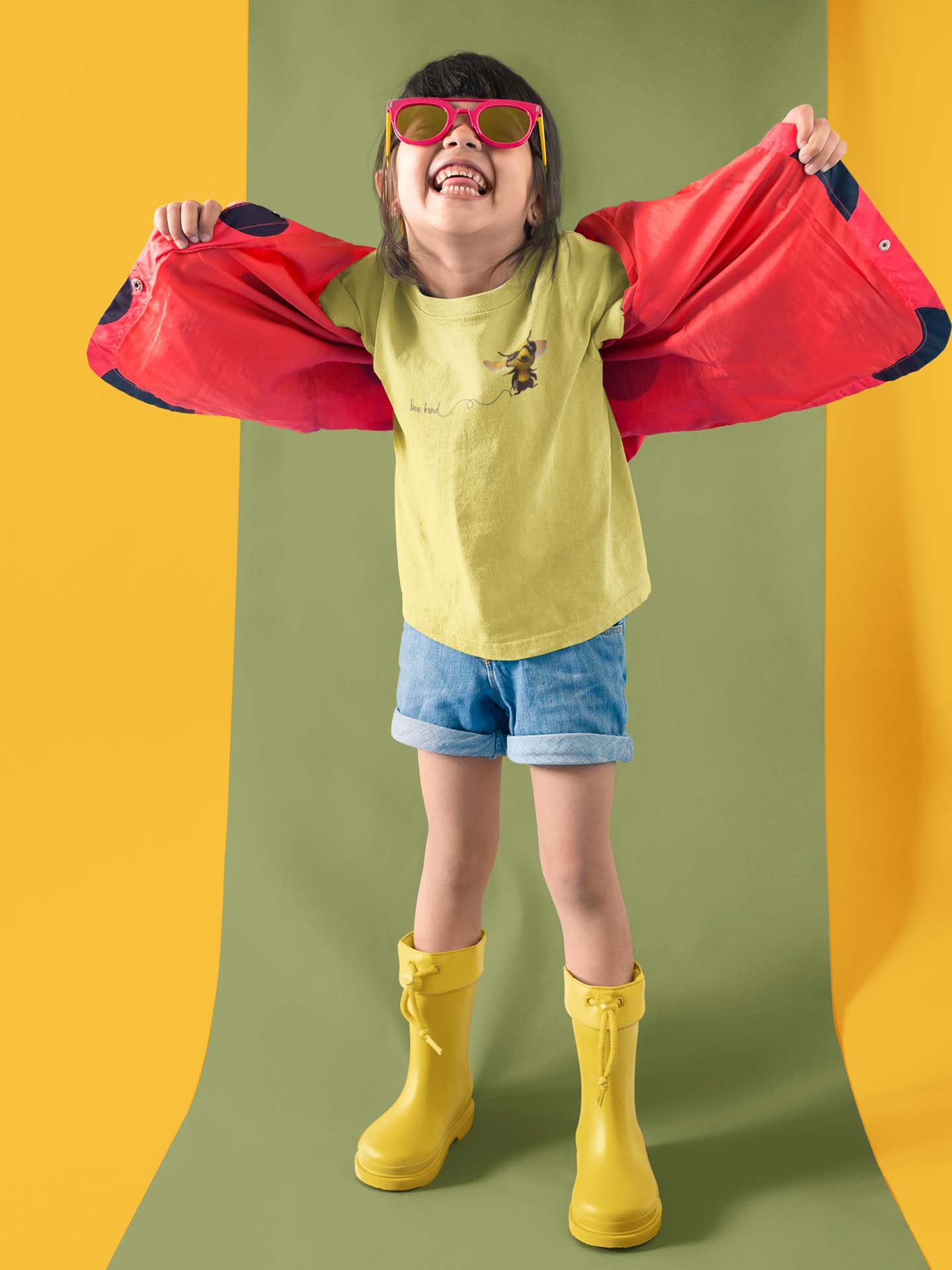 Happy girl wearing a Bee Kind T-Shirt